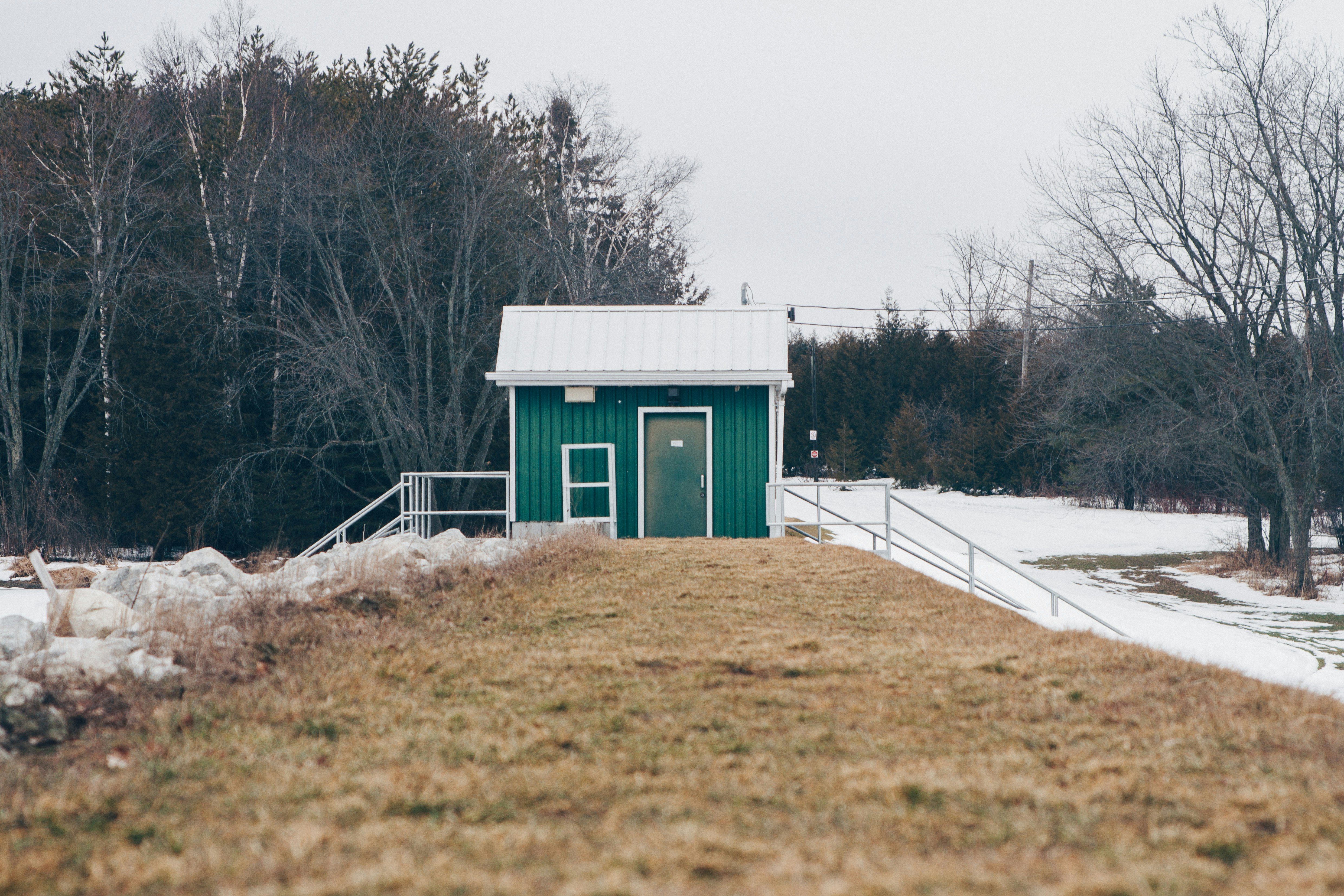 green house near trees at daytime